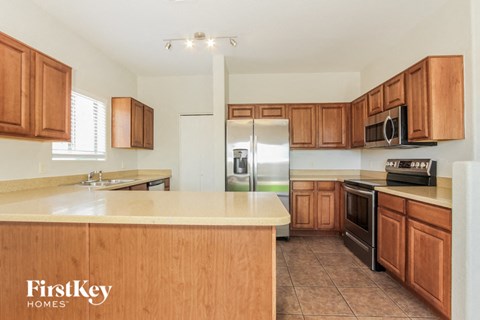 a kitchen with wooden cabinets and stainless steel appliances