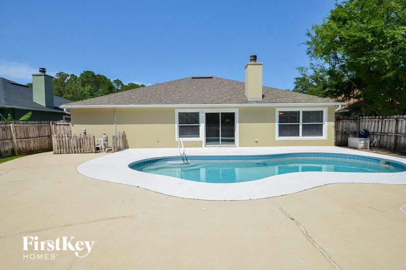 A house with a pool in the backyard.