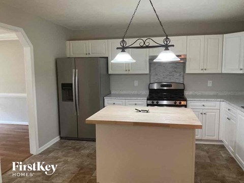 A kitchen with a wooden counter top and a stove.