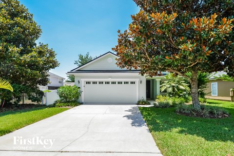 a white garage door in front of a white house