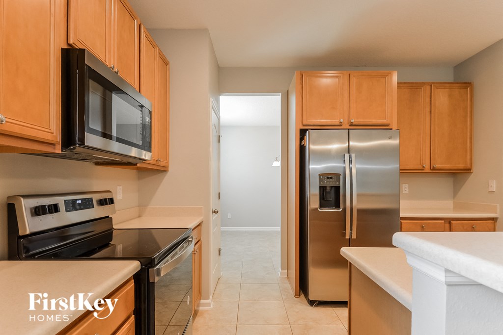 a kitchen with stainless steel appliances and wooden cabinets