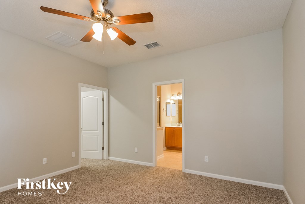 the master bedroom is spacious and has a ceiling fan