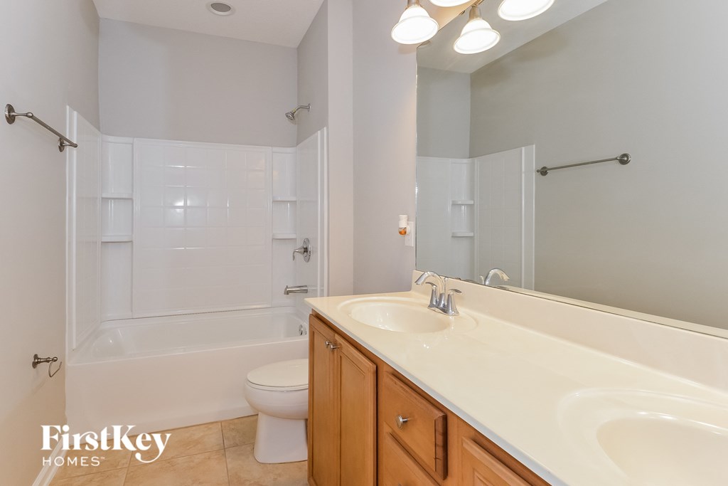a bathroom with a sink and a toilet and a bath tub