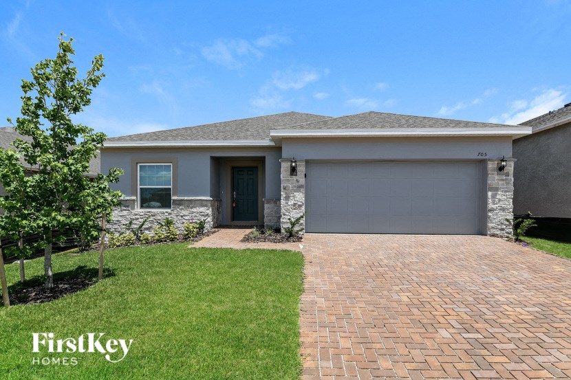 a brand new house with a driveway and grass