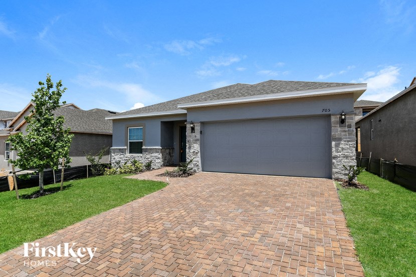 a brick driveway in front of a house