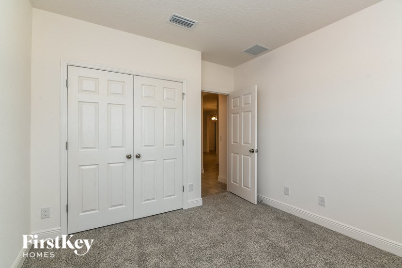 a bedroom with two closets and a door to a hallway