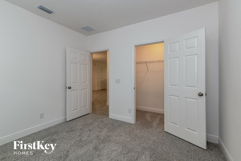 a bedroom with two closets and a door to a closet