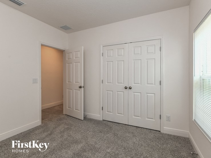 a bedroom with two closets and two doors