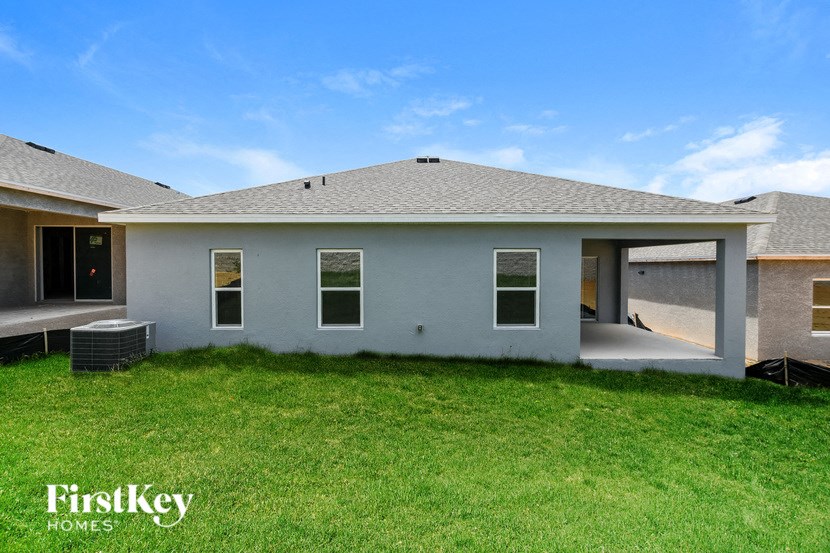 a white house with a yard and grass