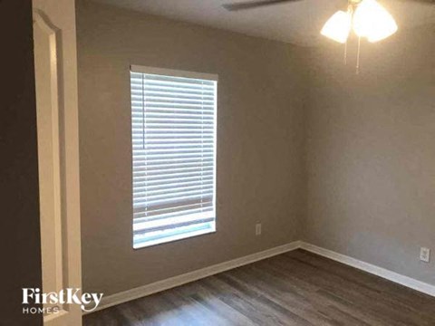 a living room with a window and wooden floors
