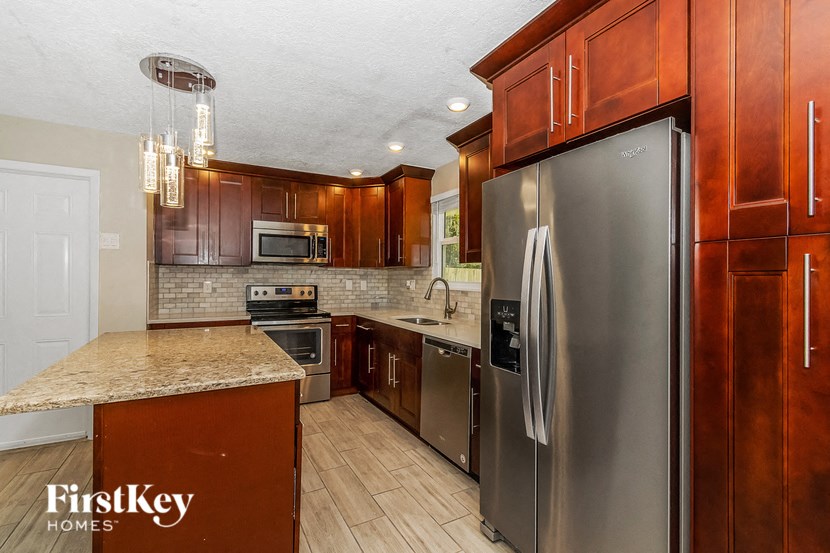 a kitchen with stainless steel appliances and wooden cabinets