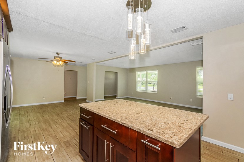a kitchen with an island and a ceiling fan