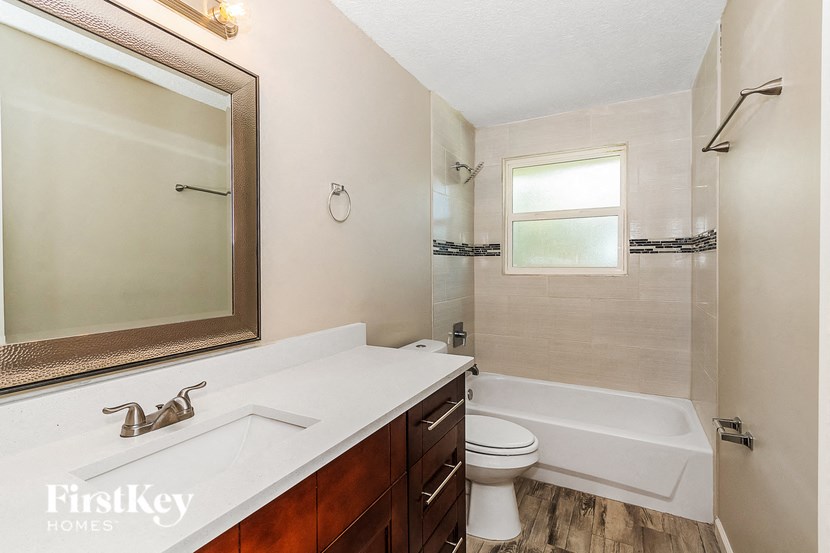 a bathroom with a sink and a toilet and a bath tub