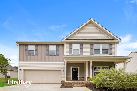 a beige house with a blue sky in the background