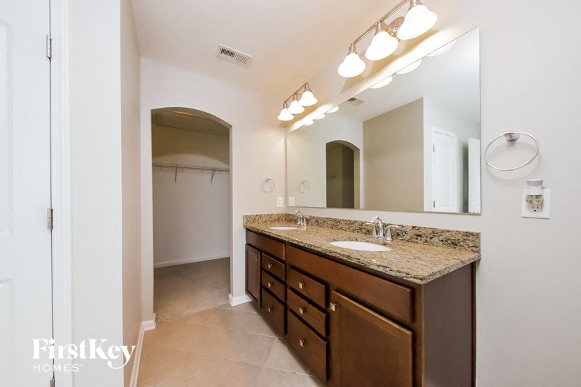 a bathroom with a sink and a mirror and a shower