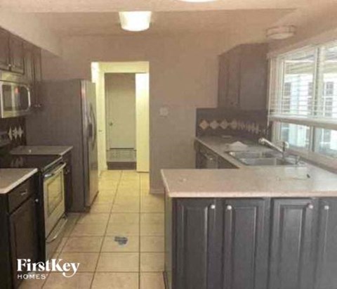 a kitchen with a sink and a refrigerator