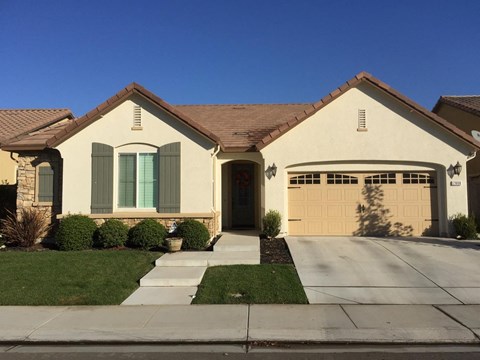 A house with a brown roof and a garage door.