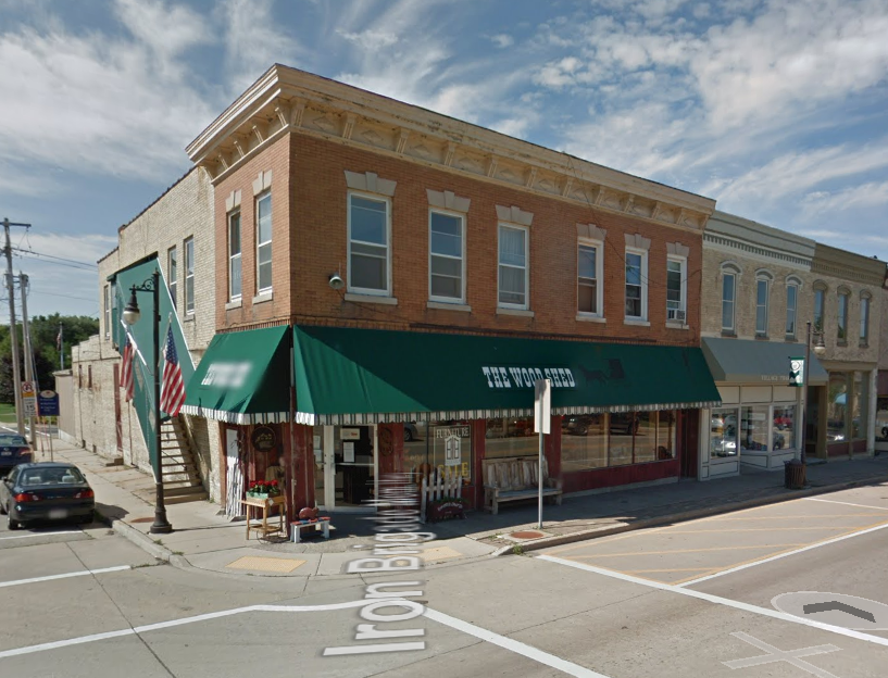 a building with a green awning on a city street