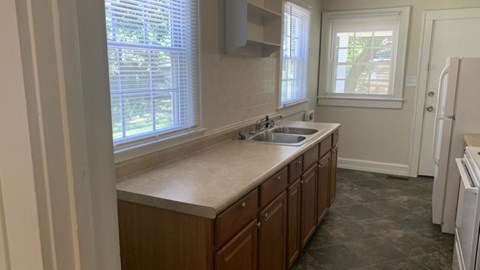 A kitchen with a sink and a window.