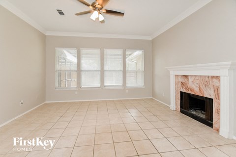 a living room with a fireplace and a tiled floor