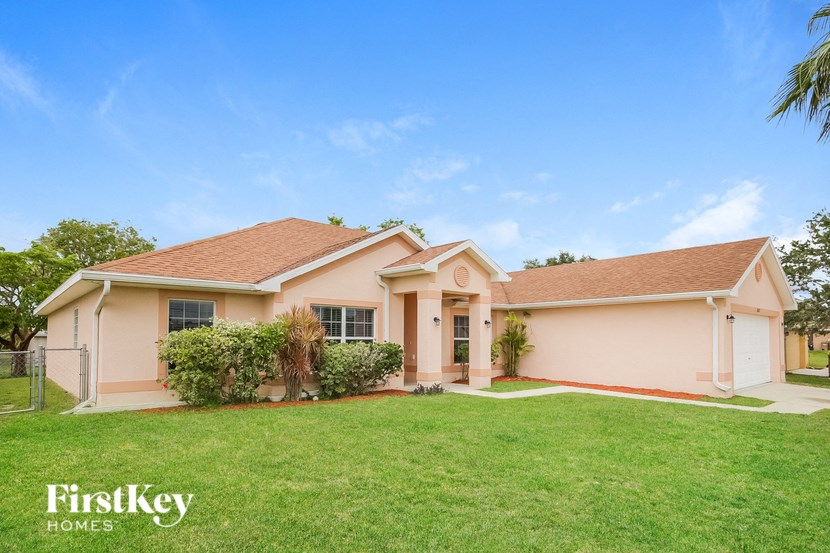 a home with a green lawn and a house