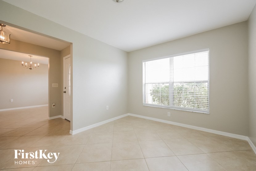 an empty living room with a large window