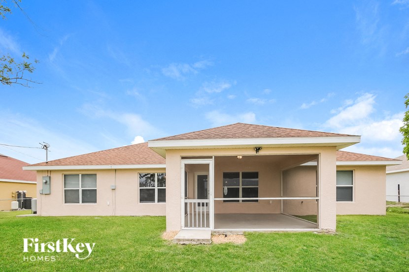 a house with a lawn and a blue sky