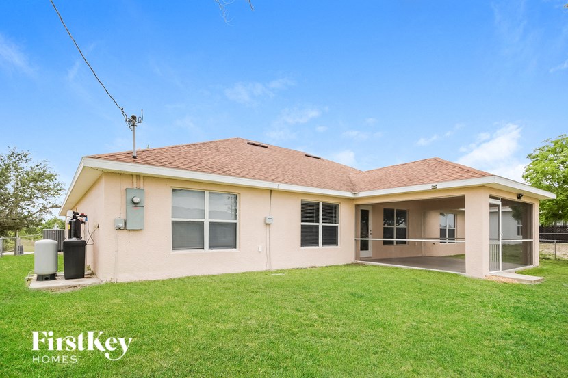 a house with a green lawn and a blue sky