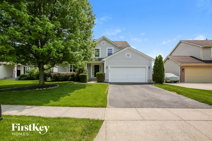 a house with a white garage door and a driveway