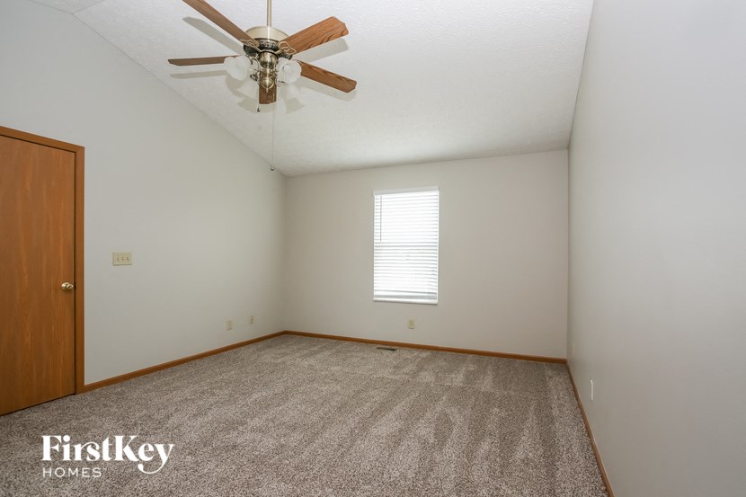 the living room of a home with a ceiling fan
