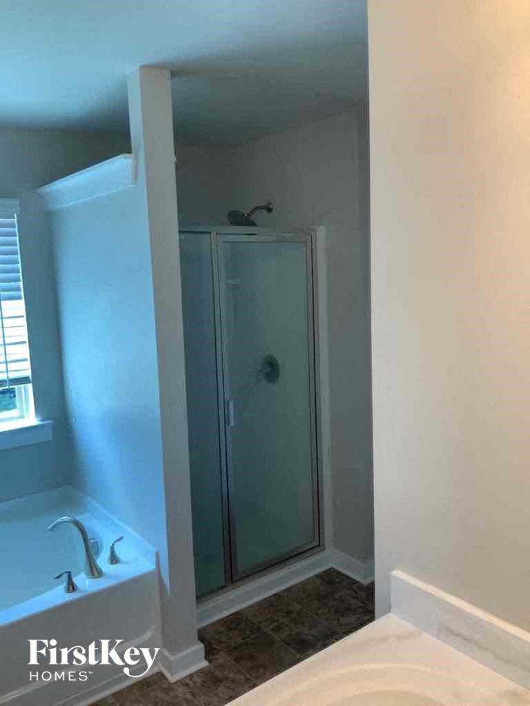 a small bathroom with a shower and a sink