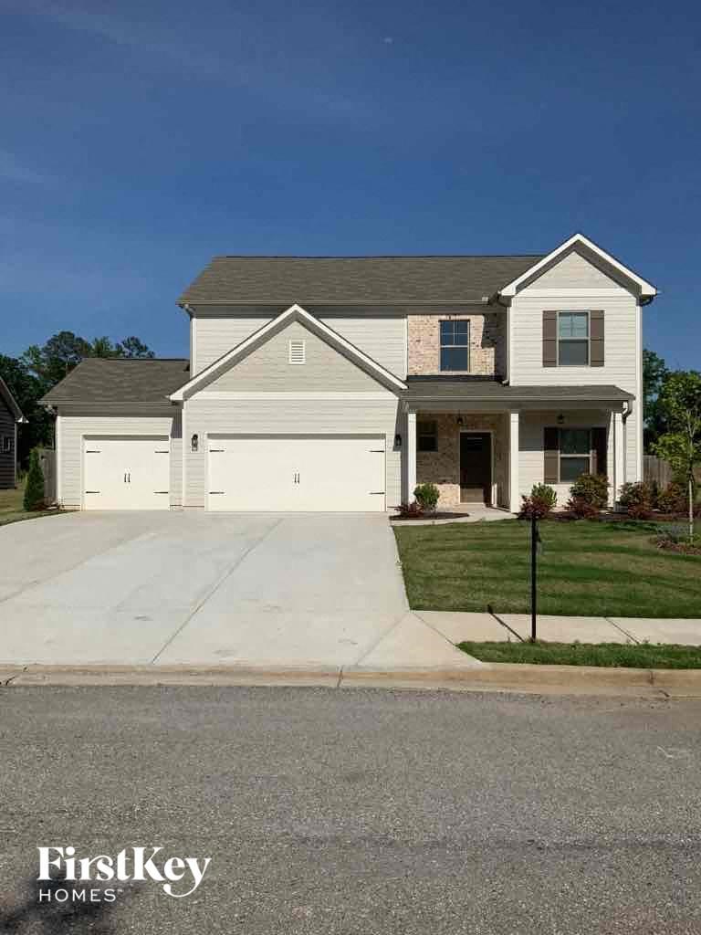 a white house with a driveway in front of it