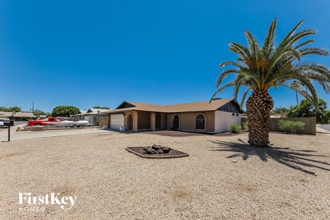 A palm tree stands in front of a house with a sign that says "FirstKey Homes.".