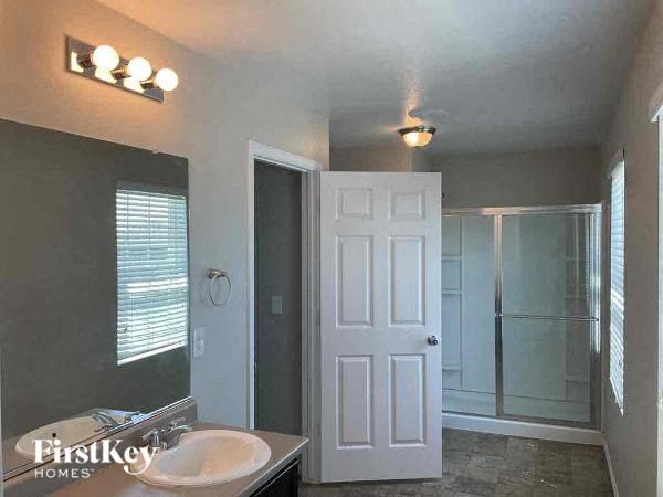 a bathroom with a white sink and a shower