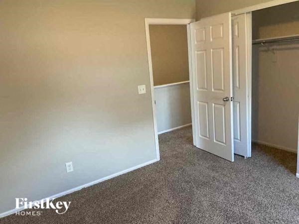 an empty room with a door and a closet