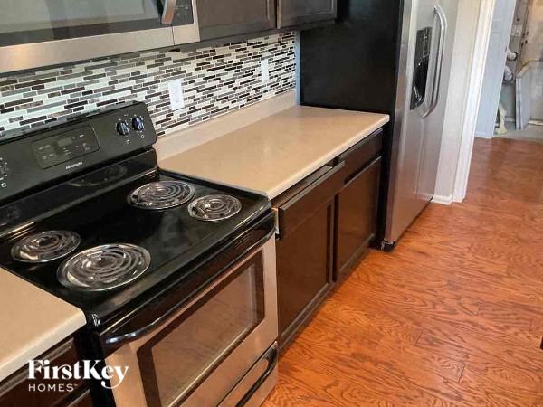 a kitchen with a stove and a refrigerator
