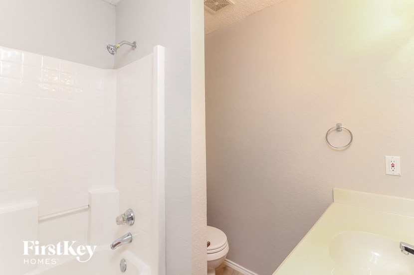 a white bathroom with a toilet and a sink