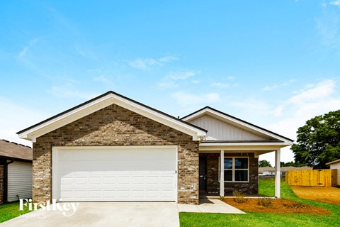 a small house with a white garage door