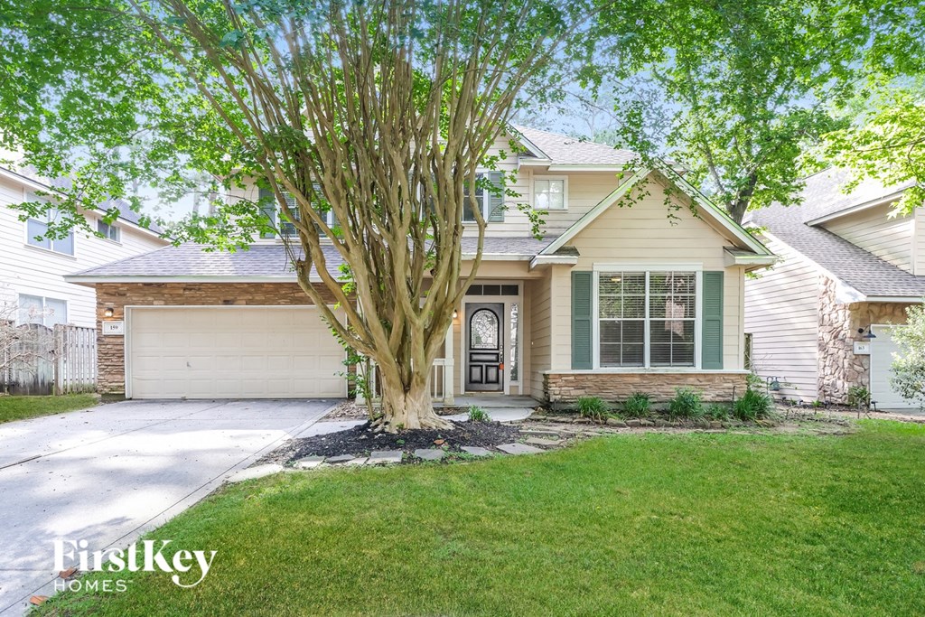 A house with a tree in front of it.