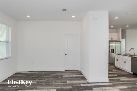 A spacious, empty room with a door and a window.