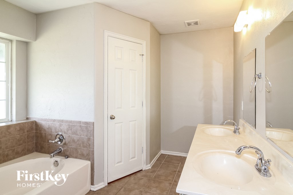 a bathroom with a sink and a mirror and a shower