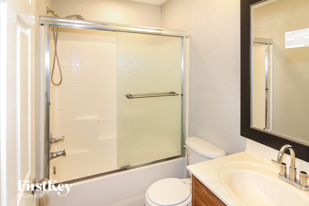 a bathroom with a shower and a sink and a toilet