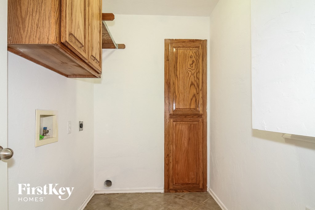an old wooden door in a room with white walls and a tile floor