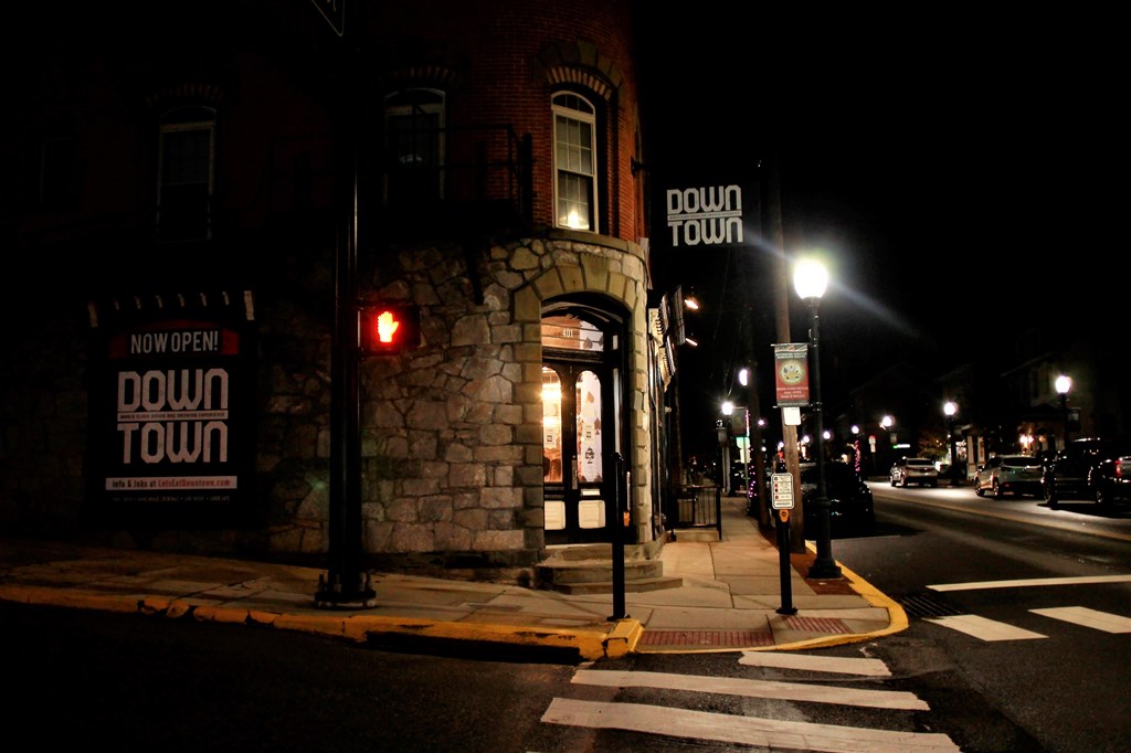 a building on a street at night with a traffic light