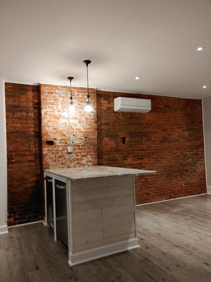 a bar in a room with a brick wall