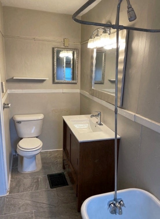 a bathroom with a toilet and a sink and a bath tub