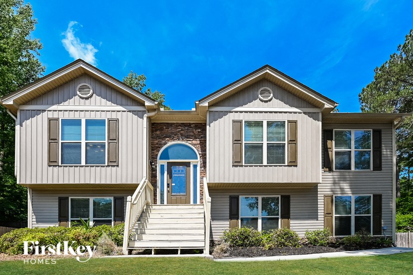a beige and brown house with a blue sky in the background