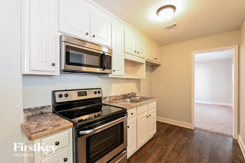 a kitchen with stainless steel appliances and white cabinets