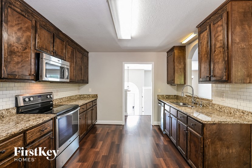 a kitchen with wooden cabinets and stainless steel appliances