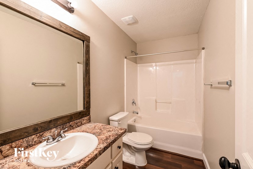 a bathroom with a sink and a toilet and a shower